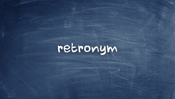 The word "retronym" written on a chalkboard.